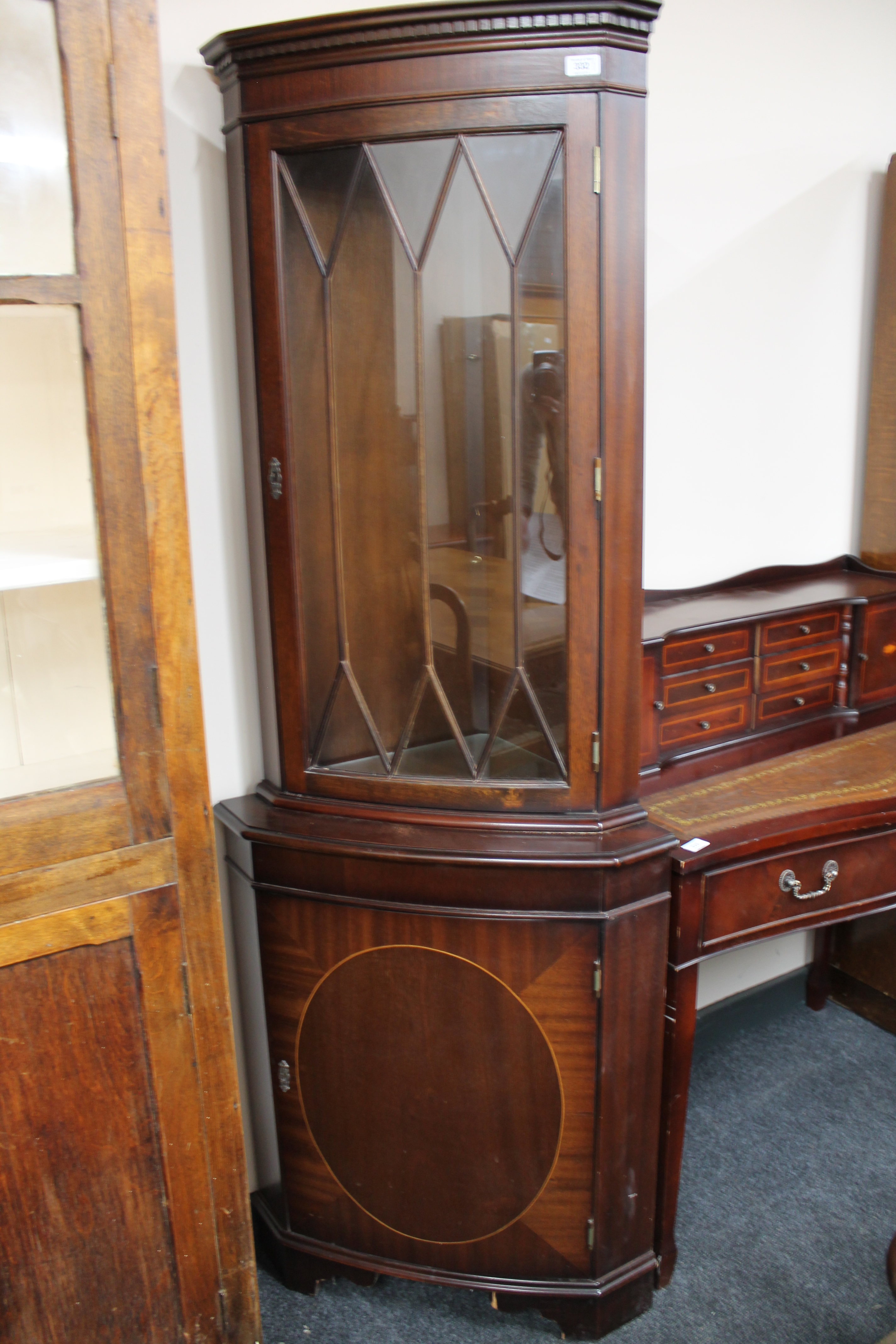 An inlaid mahogany corner display cabinet