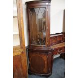 An inlaid mahogany corner display cabinet