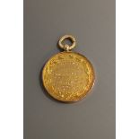 A 9ct gold disc fob presented to Lieut J D Milburn for valour in the Great War, 8.5g.