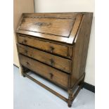 An oak bureau on twist legs