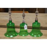 A set of three green glass cloches,