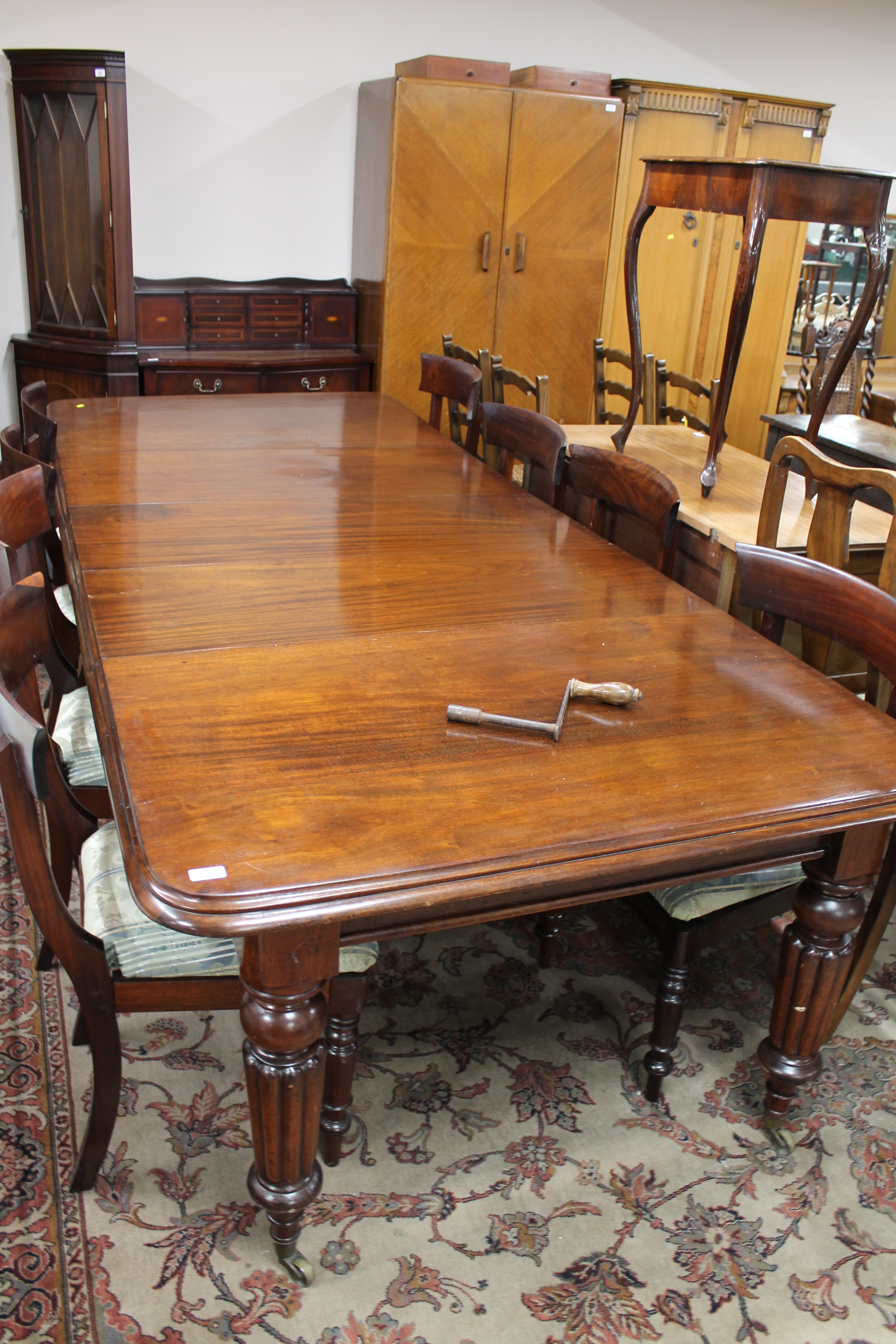 A Victorian mahogany wind-out dining table with three leaves and eight chairs CONDITION