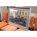 A silvered framed mirror