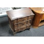 A twentieth century carved oak three drawer chest