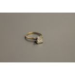 A 14ct gold solitaire diamond ring, the princess-cut stone weighing 1.