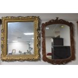 A carved oak framed wall mirror together with a decorative gilt framed mirror