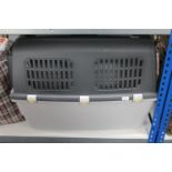 A large plastic pet carrier