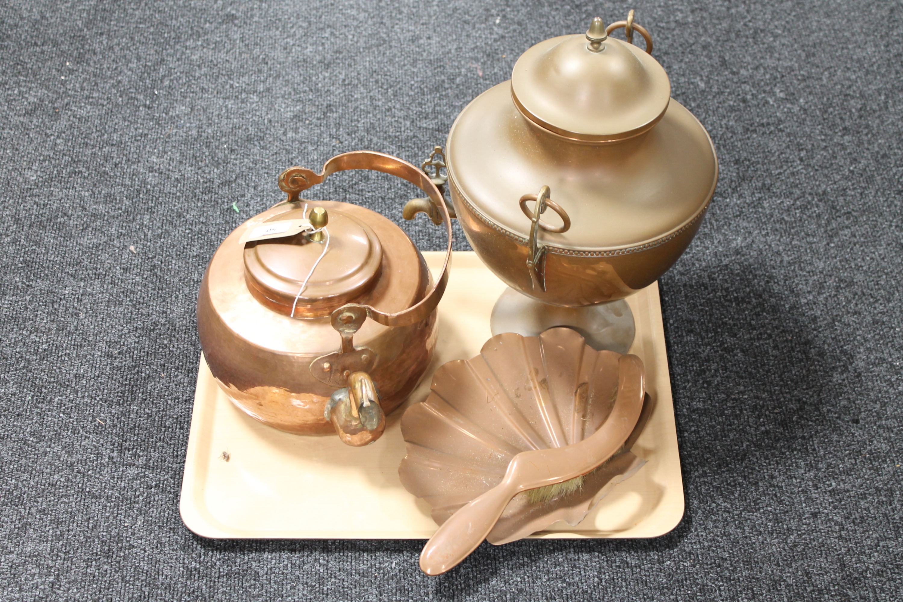 An antique copper kettle together with a copper samovar and copper hearth brush with scoop