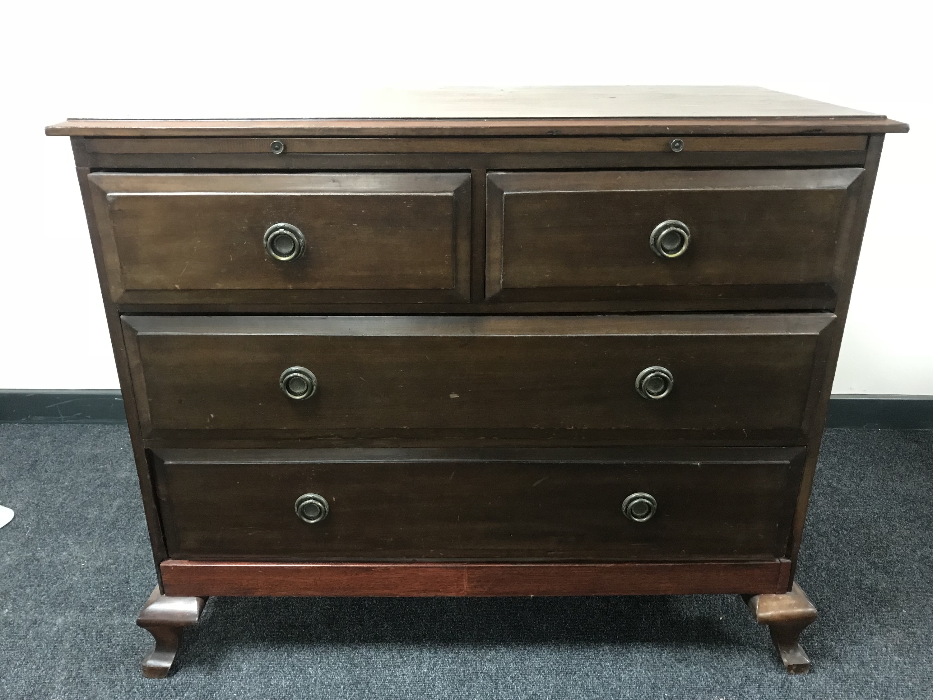 A late Victorian four drawer chest with slide