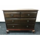 A late Victorian four drawer chest with slide