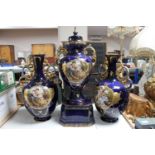 An early twentieth century blue and gilt transfer printed vase trio