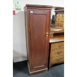 An oak gun cabinet with keys