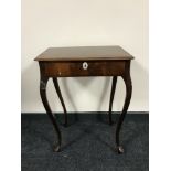 An antique mahogany sewing table