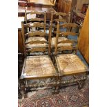 A set of four oak rush seated ladder backed dining chairs