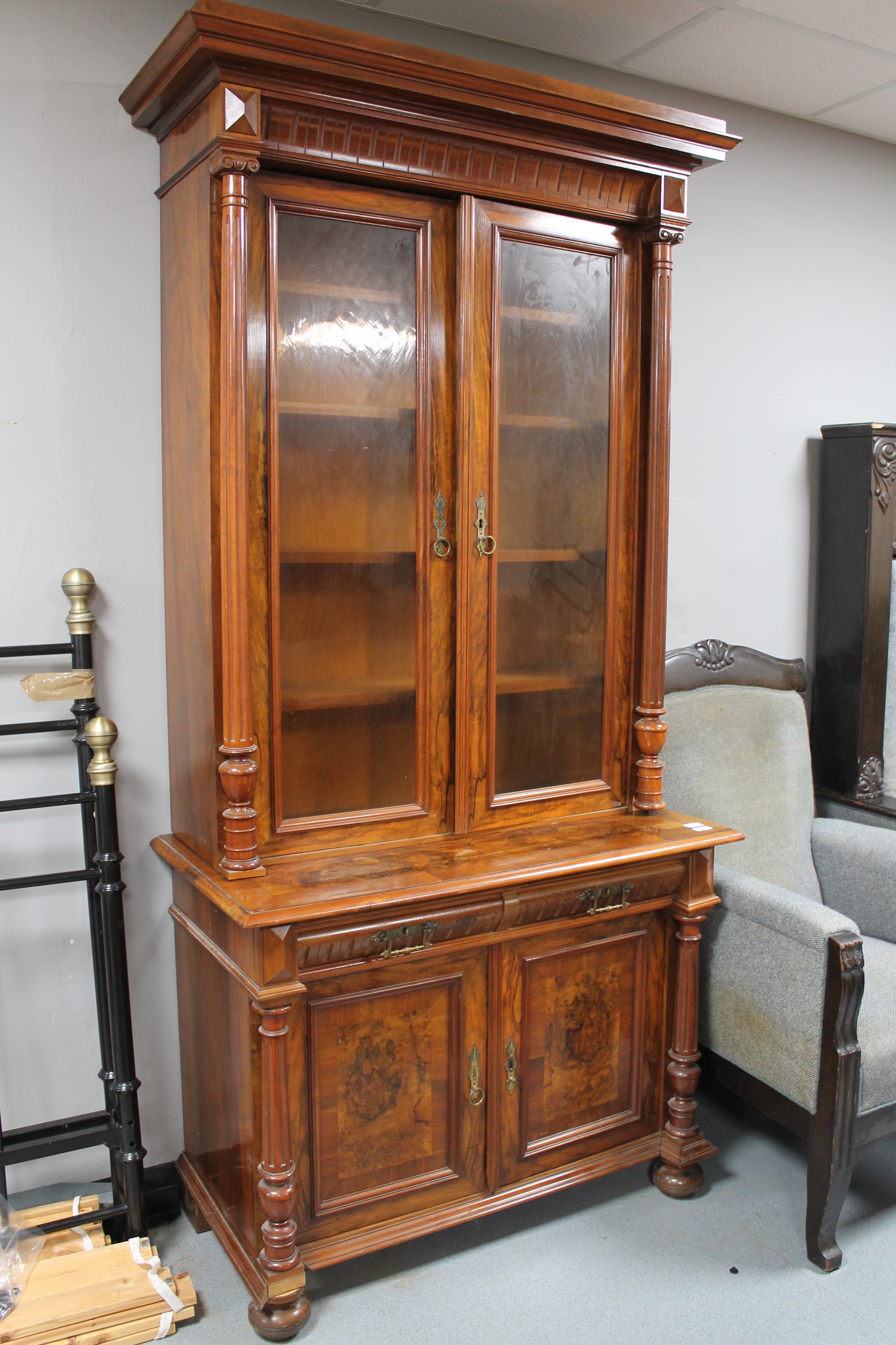 A continental walnut and mahogany bookcase with pillar supports CONDITION REPORT: