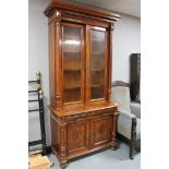 A continental walnut and mahogany bookcase with pillar supports CONDITION REPORT: