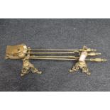 A pair of brass fire dogs and a companion set CONDITION REPORT: Generally in very