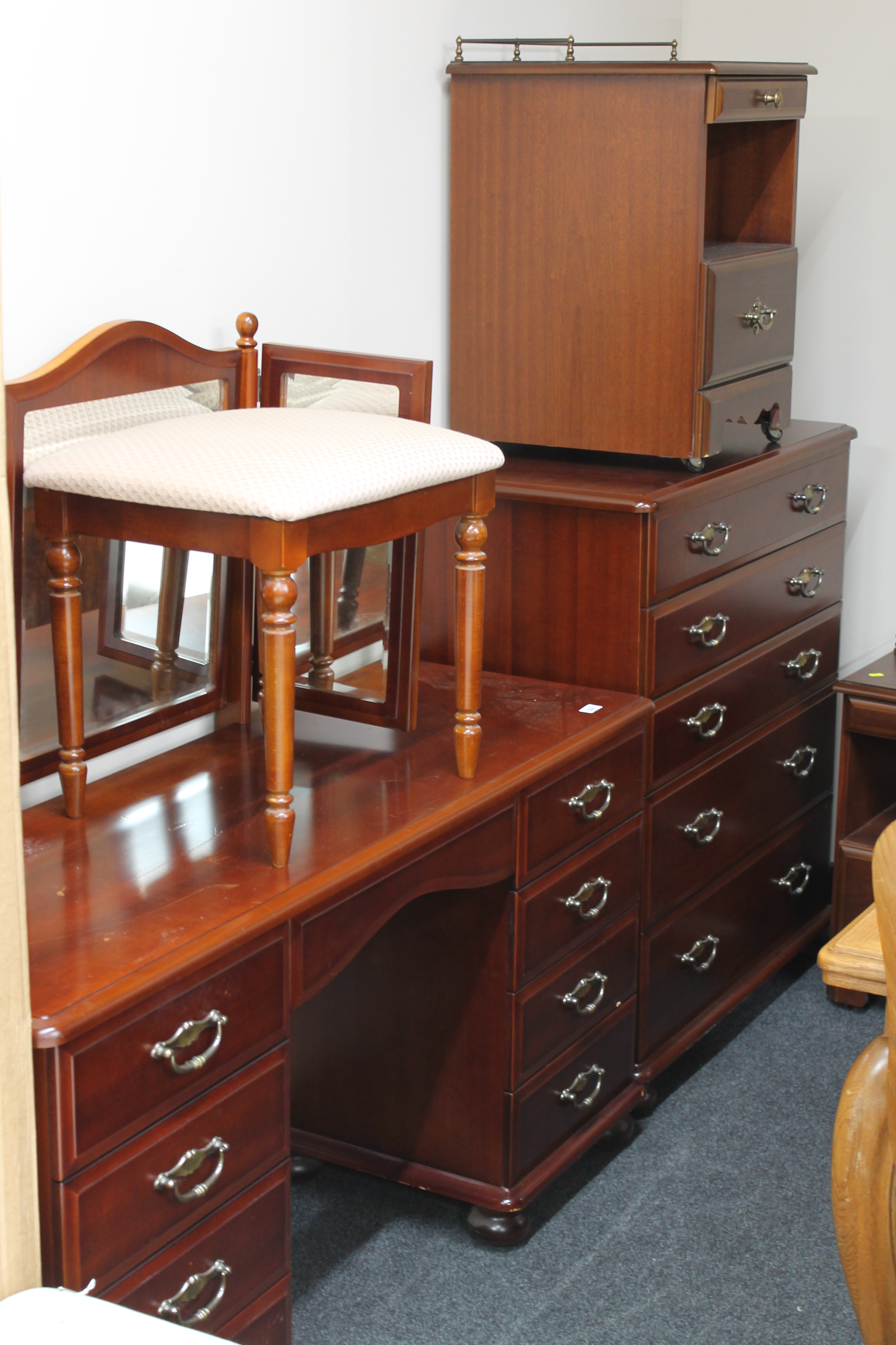 A contemporary Mcdonagh five piece mahogany bedroom suite comprising of five drawer chest,