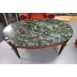 An oval French style marble topped coffee table with ormolu mounts