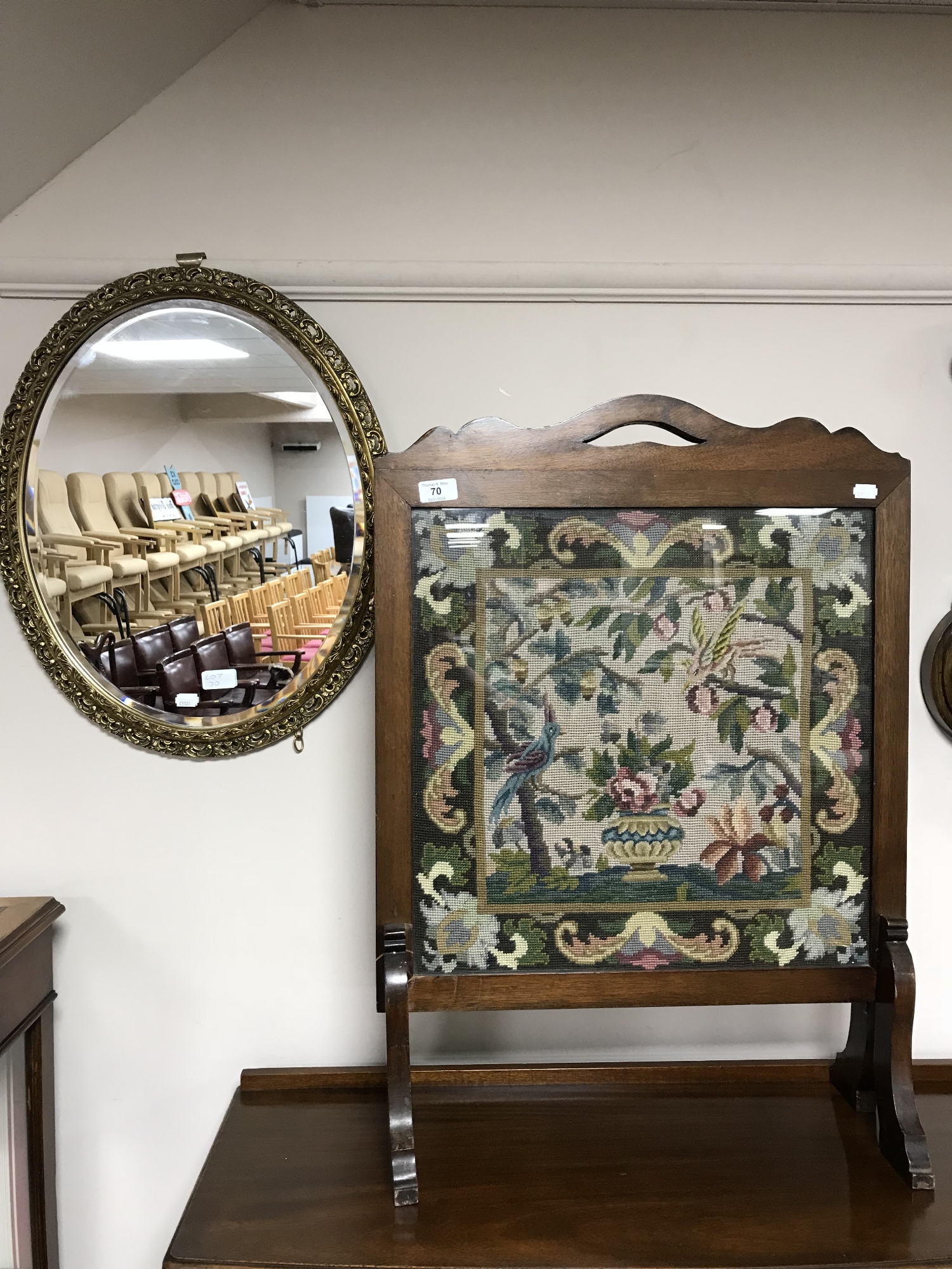 An oak framed tapestry fire screen together with an oval bevelled edge gilt framed mirror