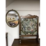 An oak framed tapestry fire screen together with an oval bevelled edge gilt framed mirror