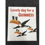 A hand painted "a lovely day for a Guinness" advertisement on board