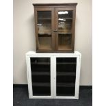 An oak double door bookcase and a painted double door bookcase