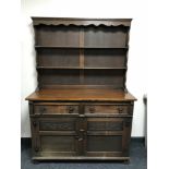 A carved oak double door dresser