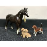 A brown gloss china horse together with two Beswick dog ornaments;