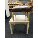 A contemporary beech effect coffee table together with a leather upholstered stool