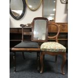 Two antique mahogany dining chairs together with a mahogany framed mirror