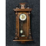 A walnut Vienna wall clock with pendulum and key