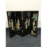 A contemporary black lacquered four way folding table screen