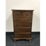 A reproduction mahogany six drawer chest