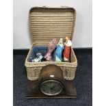 An oak mantel clock, picnic basket containing tea service, religious figures,