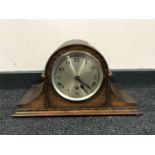 An oak mantel clock with silvered dial