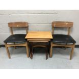 A nest of three teak G-Plan tables together with a pair of late 20th century teak dining chairs