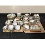 Two trays of two Japanese egg shell tea services, cased Singapore teaspoons,