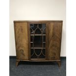 A mid 20th century walnut glazed door display cabinet