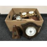 A box containing wooden barometers, metronome, miniature longcase clock,