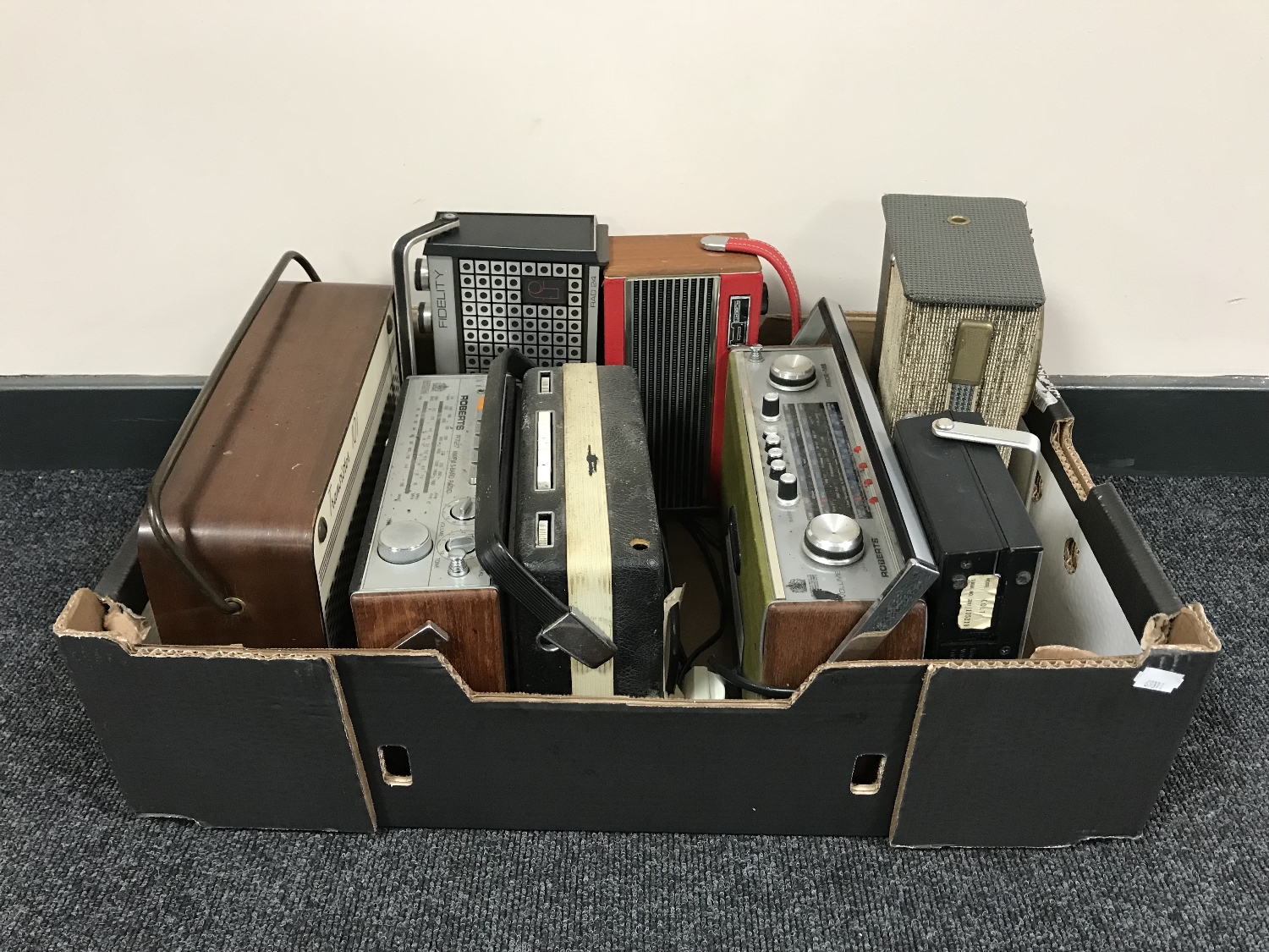 A box of eight vintage transistor radios including Roberts