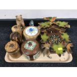 A tray containing a cuckoo clock with pendulum and weights, wooden lidded jars,