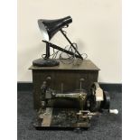 A vintage Frister and Rossmann sewing machine together with an angle poised lamp and a copper coal