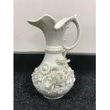 A Belleek jug with floral decoration CONDITION REPORT: Some minor chips to the