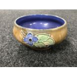 A Royal Doulton Lambeth pottery bowl with flower decoration