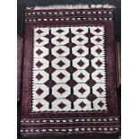 A fringed Turkish Kilim rug