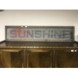 A metal Sunshine advertising sign