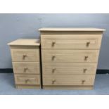 A beech effect four drawer chest together with matching three drawer bedside chest