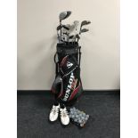 A Dunlop tour golf bag containing Dunlop irons and assorted drivers,