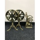 Two folding brass trivets together with a brass companion set on stand